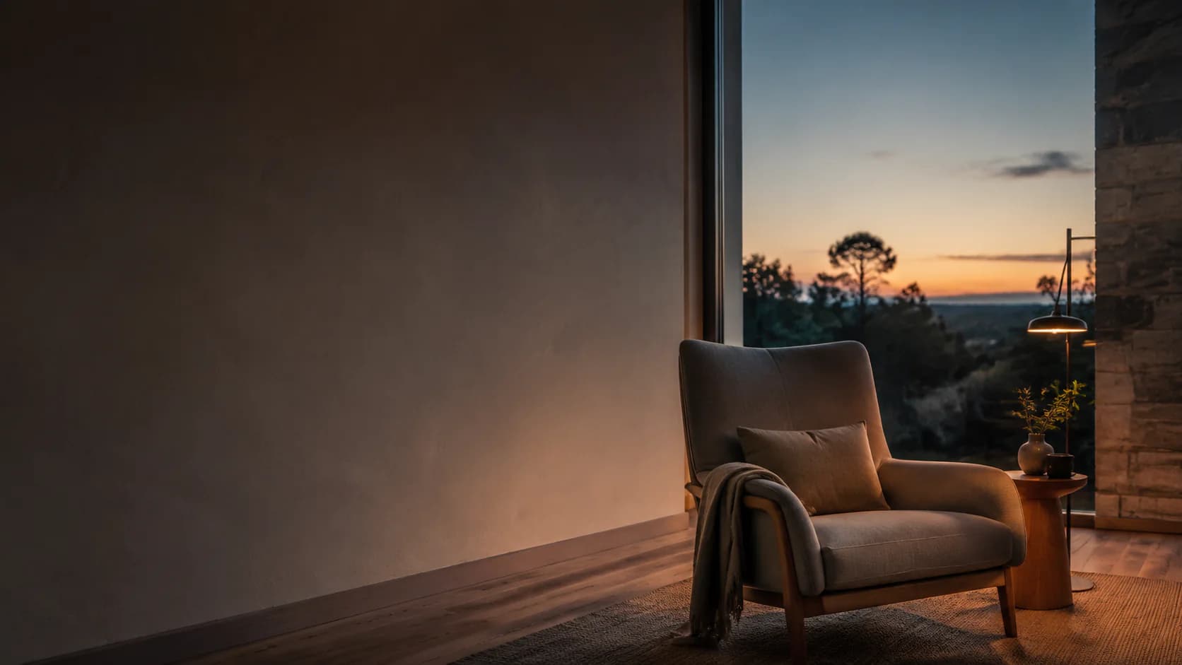 A quiet chair beside an open view at sunset.